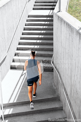 Image of young man running upstairs