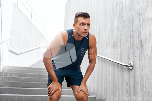 Image of tired young man doing sports outdoors