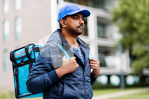 Image of indian delivery man with bag in city