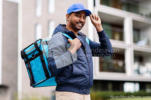 Image of happy smiling indian delivery man with bag in city