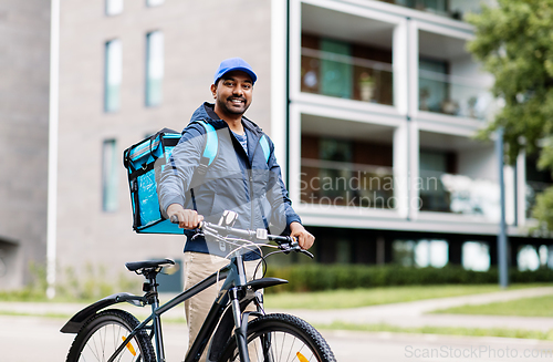 Image of indian delivery man with bag and bicycle in city