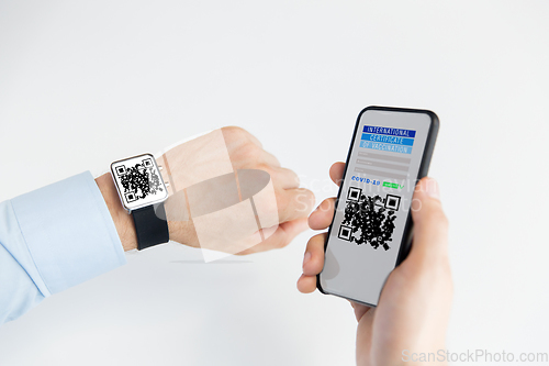 Image of hands with virtual immunity passport on smartphone