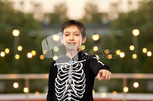 Image of boy in halloween costume of skeleton at party