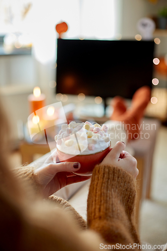 Image of woman with cream and marshmallow on halloween