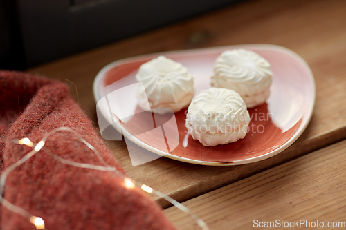 Image of meringue on ceramic plate on window sill