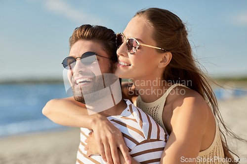 Image of happy couple hugging on summer beach