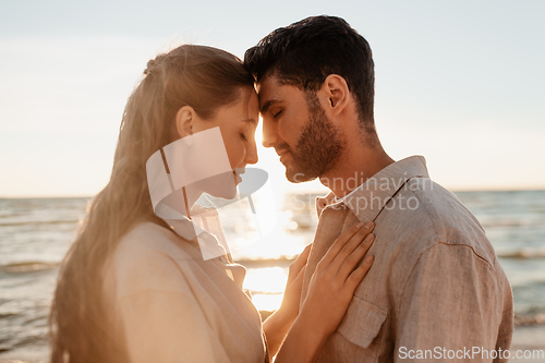 Image of happy couple with closed eyes on summer beach