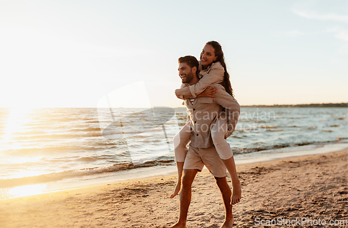 Image of happy couple having fun on summer beach