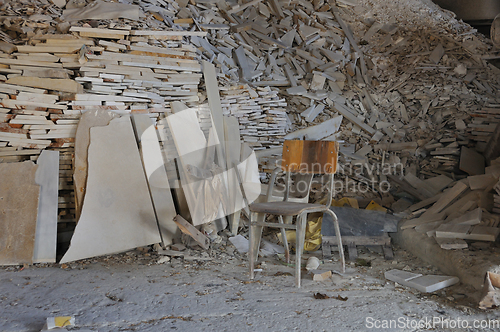 Image of dusty chair and pile of broken marble