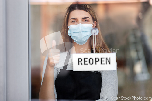 Image of woman in mask with reopen banner showing thumbs up