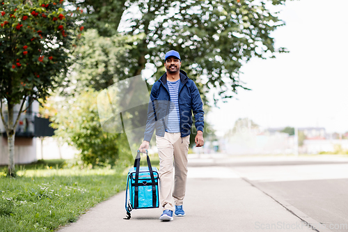 Image of indian delivery man with bag walking in city