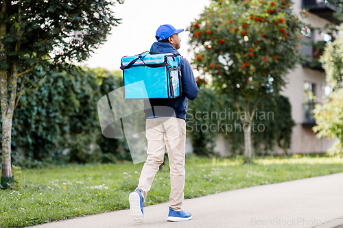 Image of indian delivery man with bag walking in city