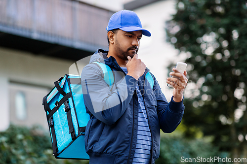 Image of indian delivery man with bag and phone