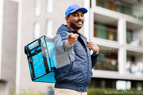 Image of indian delivery man with bag pointing to camera