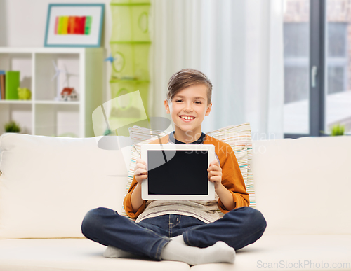 Image of smiling boy with tablet computer at home