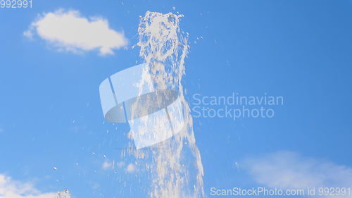Image of Top fountain water against on the blue sky.