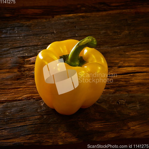 Image of Fresh yellow sweet peper onwooden background.