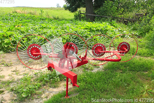 Image of agricultural tractor equipment to collect the hay