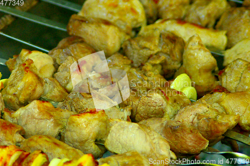 Image of appetizing pieces of fried meat on the fire