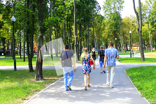 Image of people have a rest in park with big trees