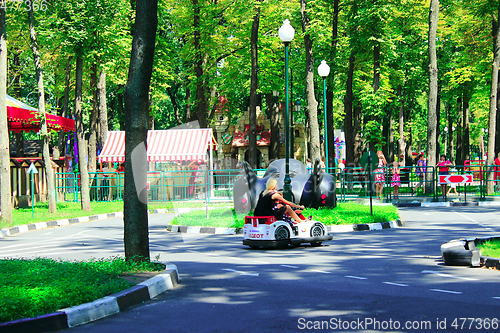 Image of children with their parents drive the electric cars