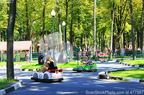 Image of children with their parents drive the electric cars