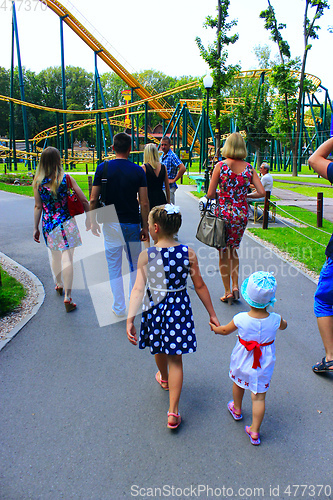 Image of people have a rest in park with big trees