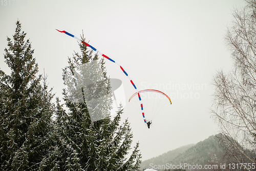 Image of Paraglider is flying in the sky