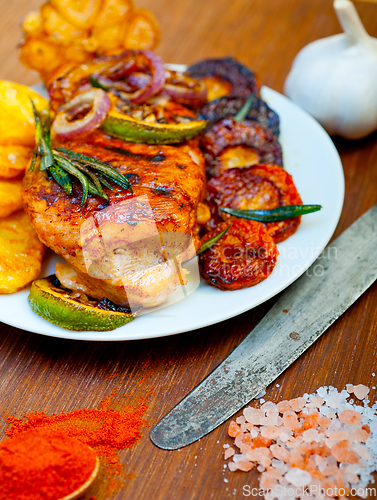 Image of roasted grilled BBQ chicken breast with herbs and spices