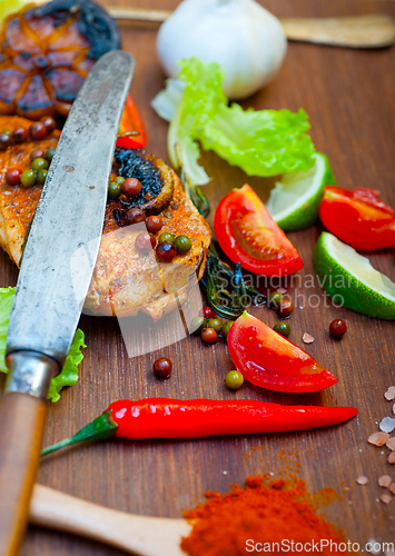 Image of wood fired hoven cooked chicken breast on wood board