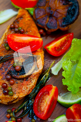 Image of wood fired hoven cooked chicken breast on wood board