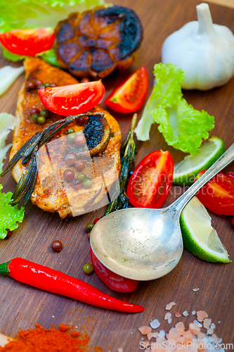 Image of wood fired hoven cooked chicken breast on wood board