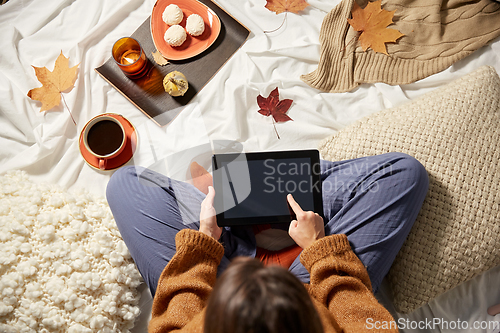 Image of woman with tablet pc at home in autumn