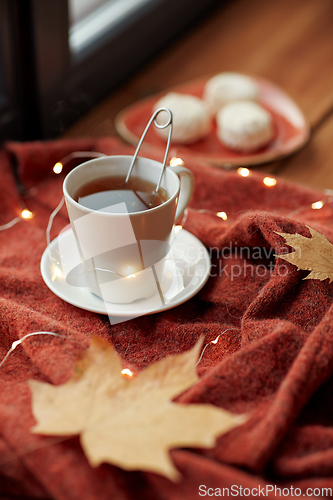 Image of cup of tea and autumn leaves on window sill