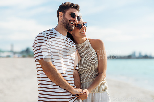 Image of happy couple on summer beach