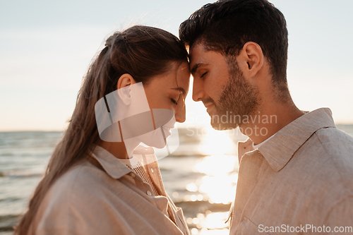 Image of happy couple with closed eyes on summer beach