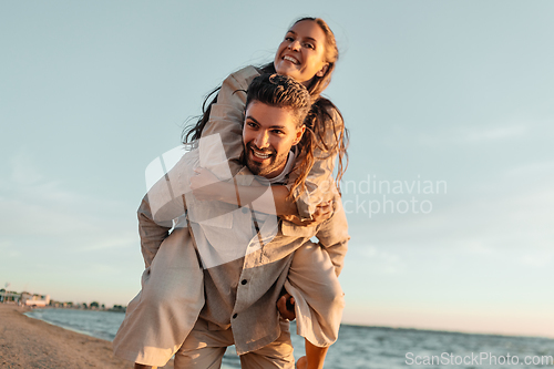 Image of happy couple having fun on summer beach