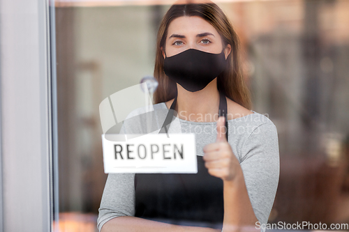 Image of woman in mask with reopen banner showing thumbs up