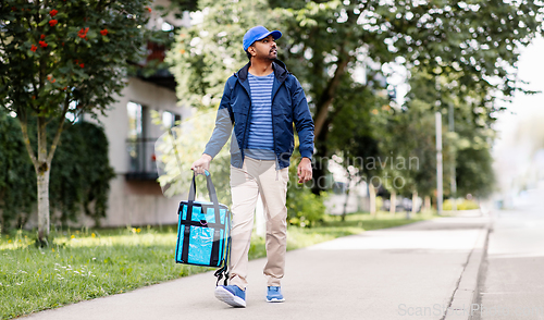 Image of indian delivery man with bag walking in city