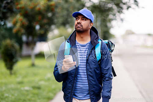 Image of indian delivery man with bag and phone