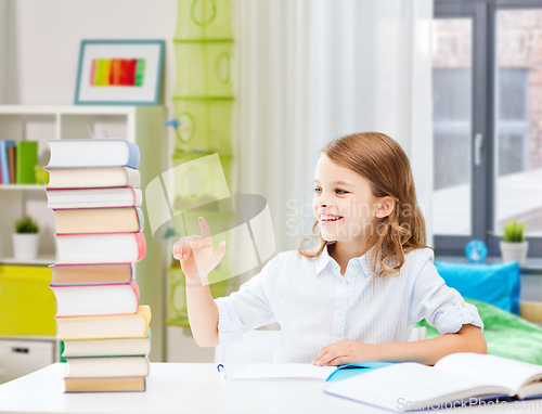 Image of happy smiling student girl reading book at home