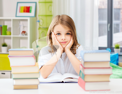 Image of bored student girl reading book at home