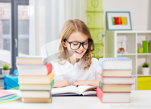 Image of happy smiling student girl reading book at home