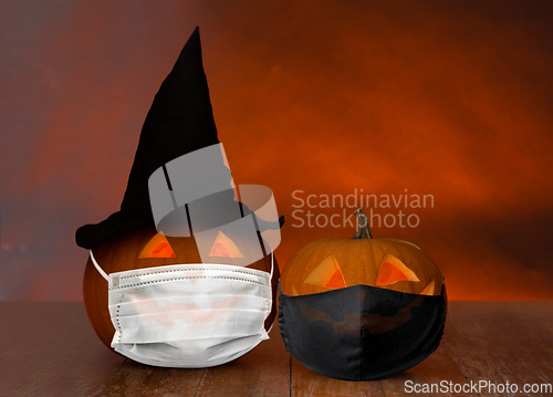 Image of carved pumpkins or jack-o-lanterns in masks