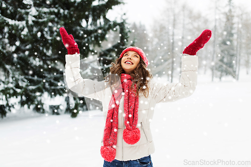 Image of happy young woman in winter park over snow