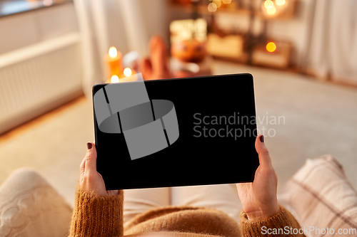 Image of woman with tablet pc at home on halloween