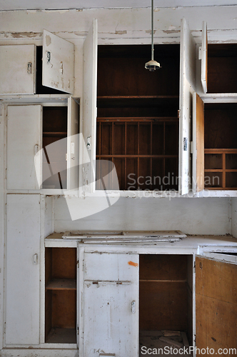 Image of empty cupboards in abandoned kitchen