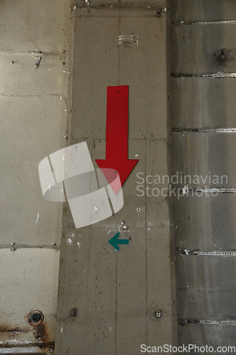 Image of factory wall and arrow signs