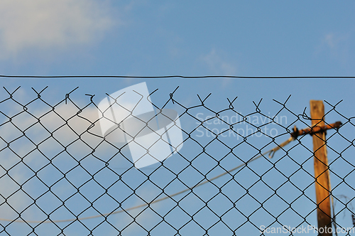 Image of chain link fence and blue sky