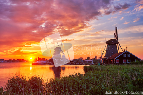 Image of Windmills at Zaanse Schans in Holland on sunset. Zaandam, Nether